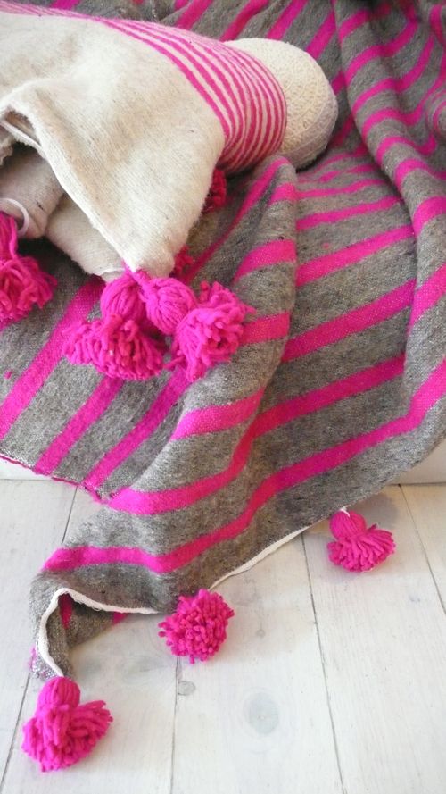 white blanket with Pink stripes and pompoms