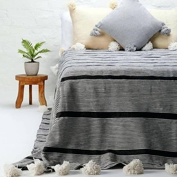 Gray Moroccan Blanket with black stripes and pompom