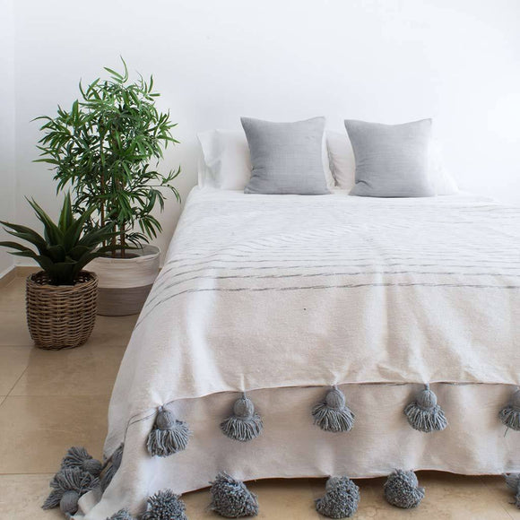 White Blanket with gray stripes and pompoms